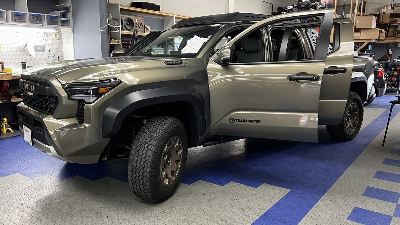 Toyota Tacoma Trailhunter pickup in the Car Audio Innovations shop with its doors open